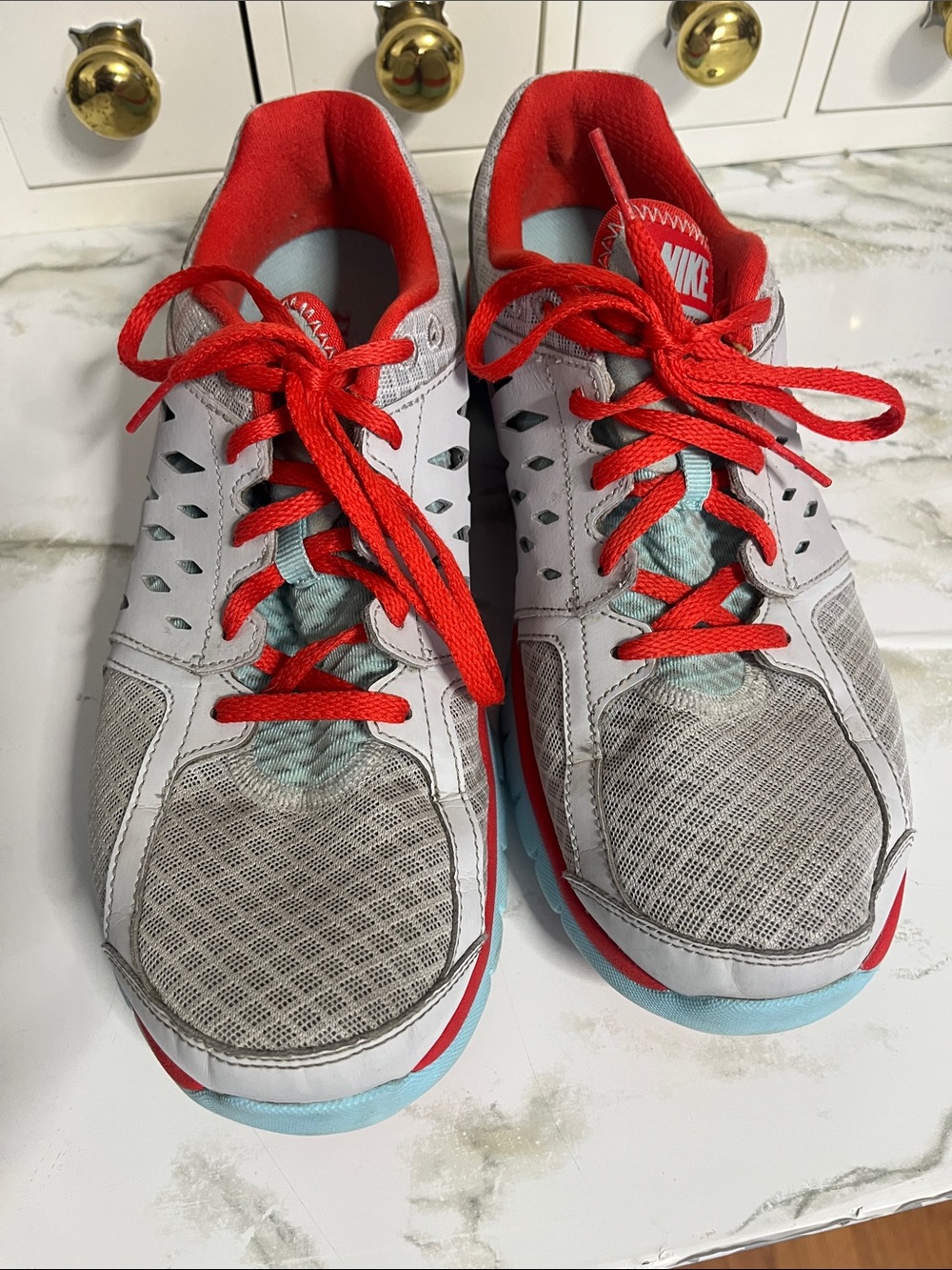 Nike Women's Gray Sneakers with Red Laces and Light Blue Accents